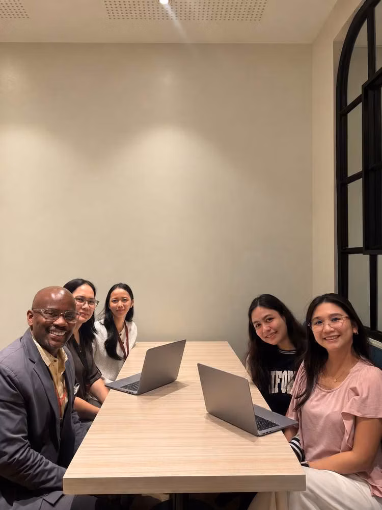 Five Talent Map Global colleagues seated around a meeting table