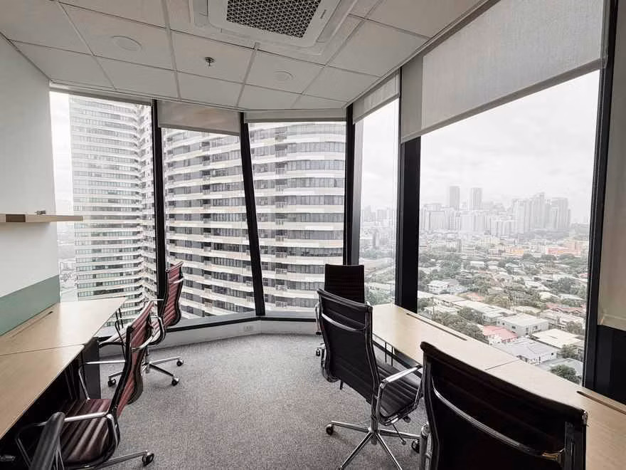 Corner office with wooden desks and a city view